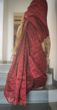 Load image into Gallery viewer, A person is seen from the back, draped in a red and beige checkered dupion silk sari with a pallu, standing on a staircase.