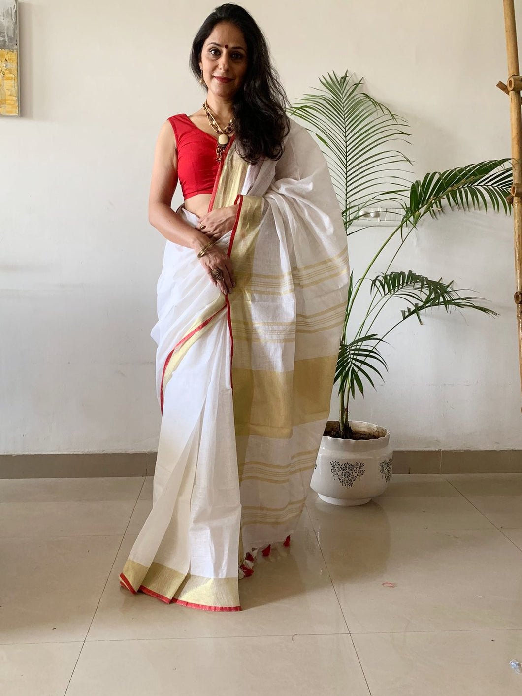 white linen saree with gold border