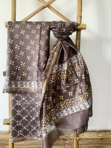 Maheshwari Silk  Kurta set in earthy brown has yellow block print on it and is paired with a matching bottom and dupatta.