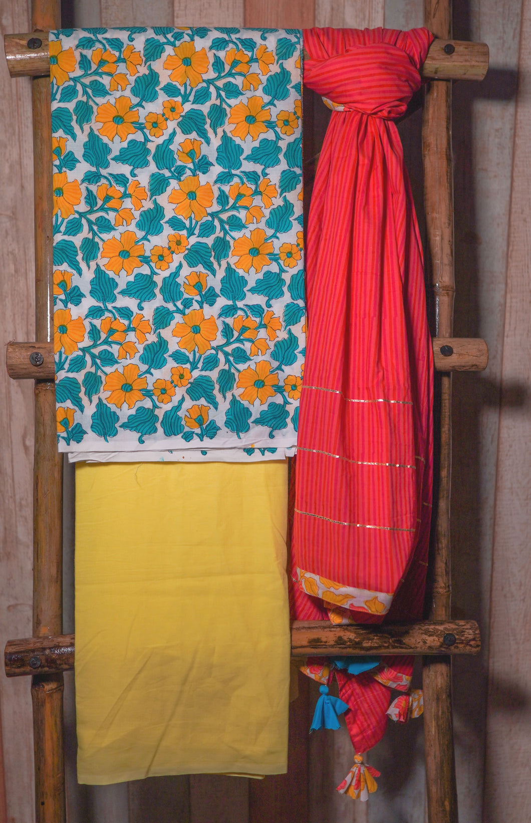 Multicolor Floral Kurta is paired with solid yellow bottom and striped dupatta