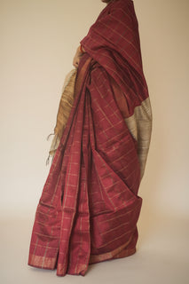Load image into Gallery viewer, A person is seen from the back, draped in a red and beige checkered dupion silk sari with a pallu, standing on a staircase.
