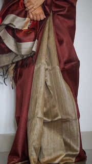 Load image into Gallery viewer, Handloom Silk Sari in wine &amp; beige is curated from the silk city, Bhagalpur. The graceful sari has an effortless drape and comes with tassels on the pallu.
