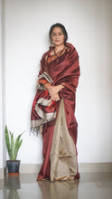 Load image into Gallery viewer, Handloom Silk Sari in wine &amp; beige is curated from the silk city, Bhagalpur. The graceful sari has an effortless drape and comes with tassels on the pallu.
