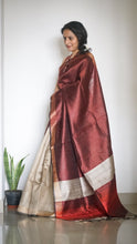 Load image into Gallery viewer, Handloom Silk Sari in wine &amp; beige is curated from the silk city, Bhagalpur. The graceful sari has an effortless drape and comes with tassels on the pallu.
